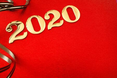 Number 2020 and ribbons on red background, New Year celebrationの写真素材