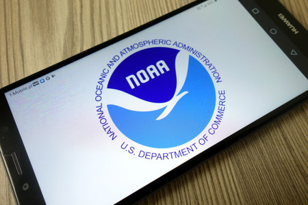 KONSKIE, POLAND - December 21, 2019: National Oceanic and Atmospheric Administration logo displayed on mobile phoneのeditorial素材