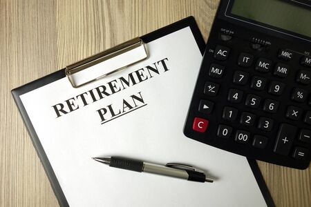 Text retirement plan on paper sheet with pen and calculator, financial conceptの写真素材