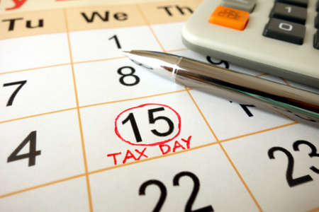 Monthly calendar showing date July 15th 2020 marked as tax day with calculator and penの写真素材