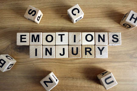 Text emotions injury from wooden blocks on deskの写真素材
