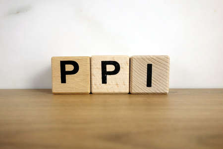 Ppi payment protection insurance abbreviation from wooden blocks, business conceptの写真素材