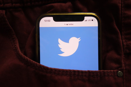 KONSKIE, POLAND - January 15, 2022: Twitter Inc logo displayed on mobile phone hidden in jeans pocketのeditorial素材