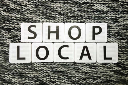 Words shop local on dark background. Domestic and regional business support conceptの写真素材