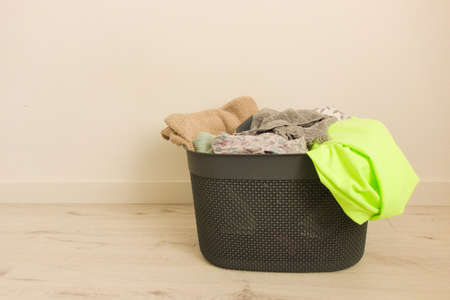Basket full of dirty laundry on floorの写真素材