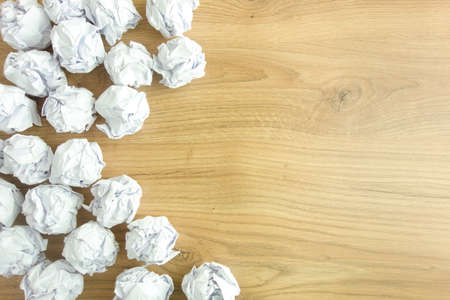Crumpled paper balls on desk. Creativity problems, lack of inspiration conceptの写真素材
