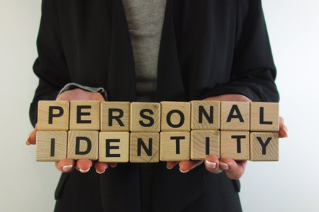 Business woman holding text personal identity from wooden blocks. Identification conceptの写真素材