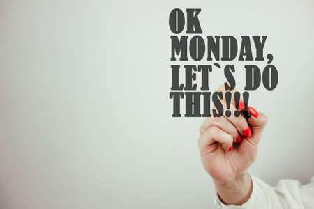 Female hand writing motivational text ok monday, lets do this. Inspirational and motivational background concept. Happy start of the weekの写真素材
