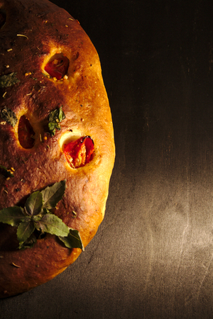 Italian focaccia bread with tomatoes and herbsの写真素材