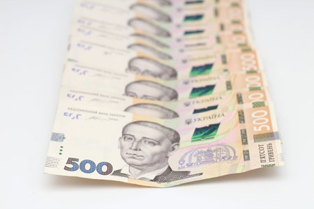 A lot of new banknotes in denominations of 500 Ukrainian hryvnias isolated on a white background...