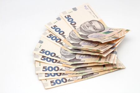 Stack of new banknotes in denominations of 500 Ukrainian hryvnias isolated on a white background with shadow. European money exchange. Ukraine currencyの写真素材