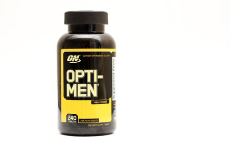 Kiev, Ukraine - December 15th, 2020: Black packaging of opti-men multivitamins on white studio backgroundのeditorial素材