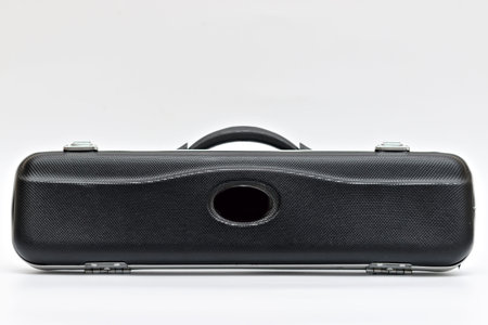 Black long case with locks for a wind musical instrument on a white background