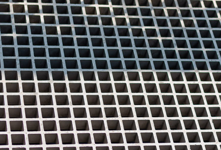 Mesh textured metal panel. Gray steel industrial surface