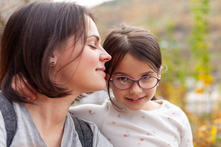 Portrait of mother and daughter in the park. focus on girlの写真素材