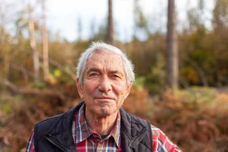 Portrait of an elderly man in the autumn forest. selective focus.