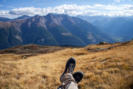 Hiking boots on the top of the mountain in the summer.の写真素材