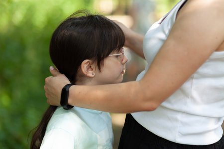Mother and daughter playing together in the park. Concept of friendly family.