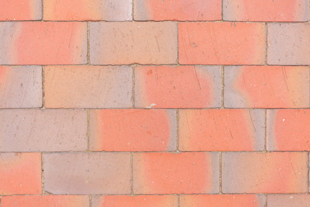 Texture image of a cobbled road made of red-orange bricks