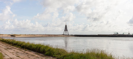 Panoramic photo of the Lighthouse in Cuxhaven, Germany, 30 m high on the seashore, used as a landmark on shipping routes.の写真素材