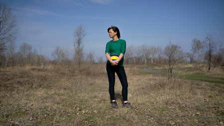 middle-aged woman playing volleyball outdoors on a sunny day. sport. active lifestyle. Fitness. volleyballの写真素材