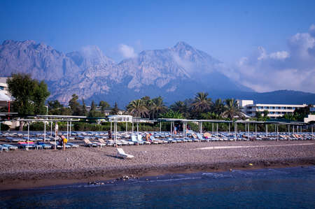 sea coast. clear weather. summer. rest. trips. beach, palm trees and mountainsの写真素材
