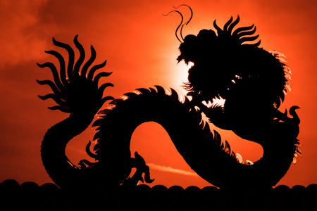 Chinese dragon. - A silhouette image of chinese dragon statue in dragon chinese temple. Sun dragon position at dragon eye.の写真素材