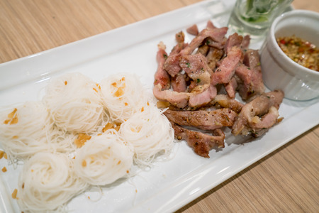 Thai style grilled pork neck with noodle and spicy sauce. Thai cuisine.の写真素材