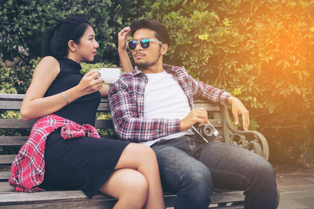 Young couple spending time together in the park in summer sunny day. Happy couple expressionの写真素材