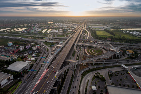 Aerial highway junction. Busy highway from aerial view. Highway shape like number 8 and infinity sign. Urban highway and lifestyle concept. Highway taken in the eastern highway of Bangkok Thailand.の写真素材