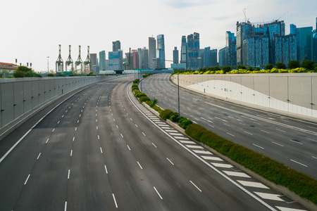 Empty road in modern city. Background of road or highway and city skyline in Singapore.の写真素材