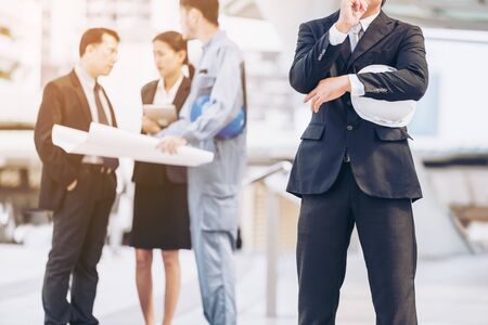 Engineering team - Group of engineer, business man and business woman in engineering construction business. Concept of teamwork, success, construction project, engineering business people concept.の写真素材