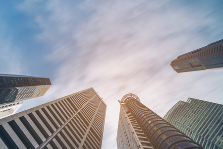 Business buildings skyline looking up with blue sky. Business downtown and skyscrapers, high-rise buildings, modern architecture buildings.の写真素材