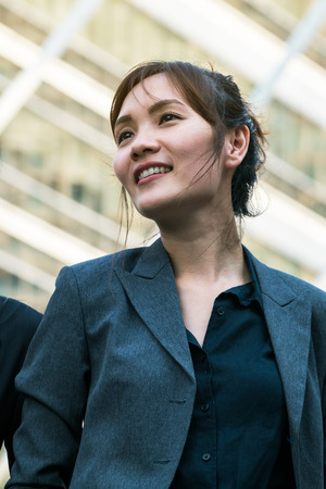 Business woman standing, turning face upwards with confidence. Concept of confident business woman, woman leadership.の写真素材