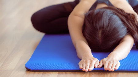 Woman practicing yoga pose in gym, close up view. Healthy lifestyle and wellness concept.の写真素材
