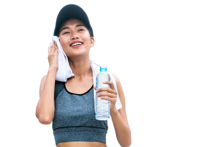 Isolated image of sport woman with drinking water in water bottle after running exercise on hot summer day isolated on white background.の写真素材