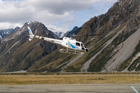 Mt Cook, New Zealand - Dec 4, 2016: Tourist helicopter flys in the mountain area in Mt Cook National Park, New Zealand. The helicopter service offers scenic flights, glacier landing, emergency rescue.のeditorial素材
