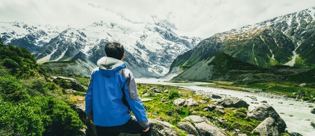 Man traveling in mountain ranges landscape of Mt Cook National Park. Mt Cook, the highest mountain in New Zealand, is known for scenic landscape, outdoor travel inspiration and mountain trekking.の写真素材