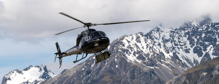 Mt Cook, New Zealand - Dec 4, 2016: Tourist helicopter flys in the mountain area in Mt Cook National...