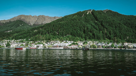 Queenstown lakefront city center shot at Lake Wakapitu, the famous lake of Queenstown, center of tourism, water sport and boat tours, South Island of New Zealand.の写真素材