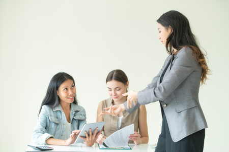 Multicultural businesswomen working group discuss in group meeting at the office. Cooperation of ethnic diversity.の写真素材