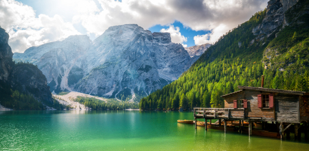 Braies Lake in Dolomites mountains Seekofel in background, Sudtirol, Italy. Lake Braies is also known as Lago di Braies. The lake is surrounded by the mountains which are reflected in the water.の写真素材