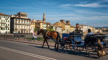 Florence, Italy - Sep 30, 2017: Horse drawn carriage travels on the street on Florence, Tuscany, Italy. Florence is the center of arts and cultures and the famous travel destination of central Italy.のeditorial素材