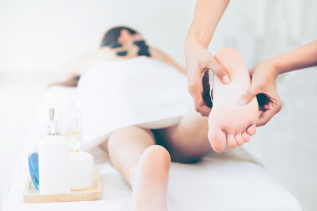 Foot spa massage treatment by professional massage therapist in luxury spa resort. Wellness, stress relief and rejuvenation concept.の写真素材