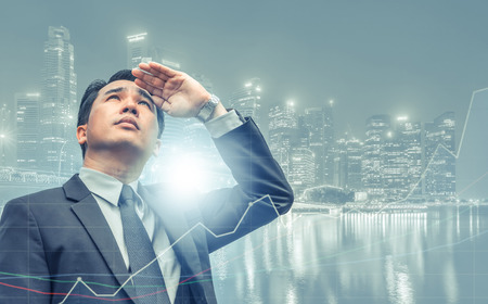 Double exposure - Business leader vision for success, looking away with modern buildings in city background. Concept of talented leadership.の写真素材