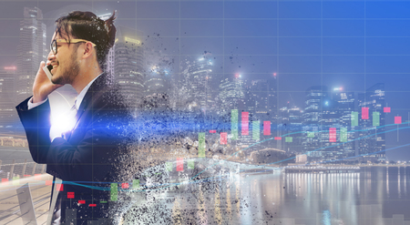 Surreal Image of Communication Concept - Young businessman using mobile phone with modern city buildings background. Future innovation technology and internet of things ( IOT ).の写真素材