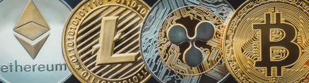 Bitcoin and cryptocurrency investing concept - Physical metal Bitcoin coins with black shinny...