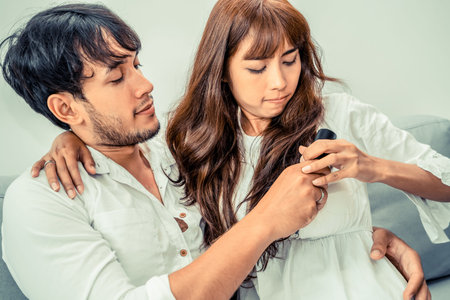 Young couple fight for TV remote on sofa in home living room in the morning.の写真素材