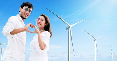 Happy couple of man and woman making heart sign gesture with each of their hand together.の写真素材