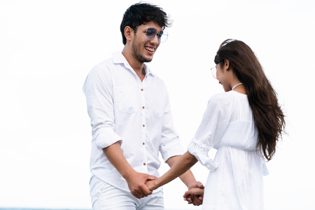 Happy couple going honeymoon travel on tropical sand beach in summer.の写真素材